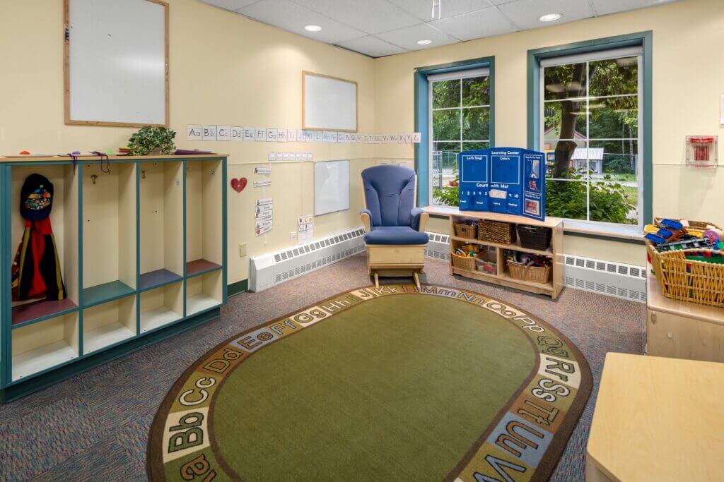 Chair and alphabetical sitting rug inside Early Learning For Everyone classroom