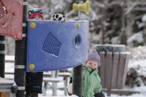Kids playing outside at the Early Learning For Everyone playground